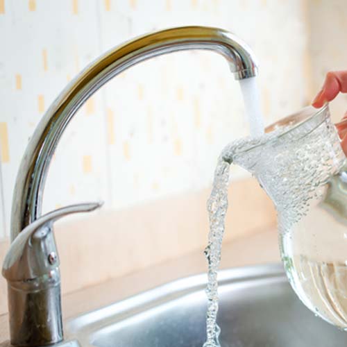 Filling a drinking water pitcher from water faucet | Drinking Water Solutions