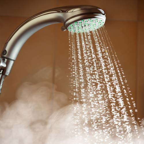 Shower head with flowing hot water and steam | Water Heater Services